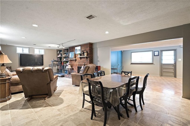 450 Ruth Ewing Rd, Liberty, MO 64068 - dining space with a textured ceiling, rail lighting, and recessed lighting