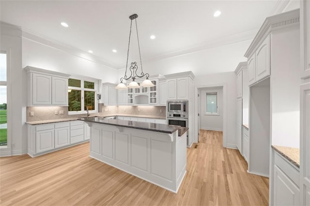 14005 Dearborn St, Overland Park, KS 66223 - kitchen featuring appliances with stainless steel finishes, tasteful backsplash, glass insert cabinets, light wood-style floors, and crown molding