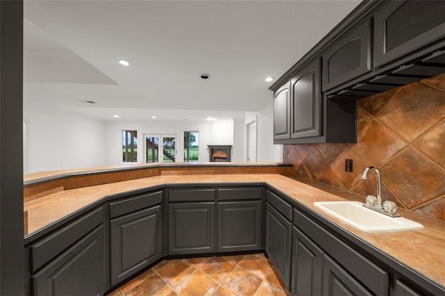 14005 Dearborn St, Overland Park, KS 66223 - kitchen featuring recessed lighting, light tile patterned floors, tasteful backsplash, light countertops, and a fireplace