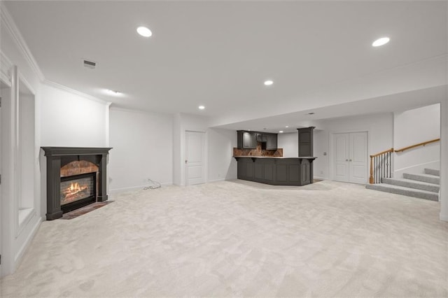 14005 Dearborn St, Overland Park, KS 66223 - unfurnished living room featuring light colored carpet, ornamental molding, recessed lighting, bar area, and stairs