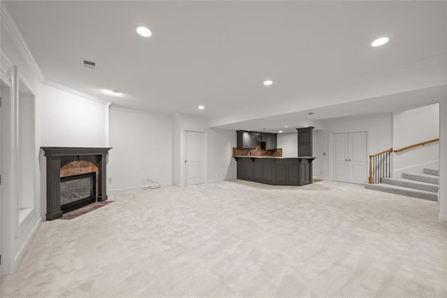 14005 Dearborn St, Overland Park, KS 66223 - unfurnished living room featuring light colored carpet, ornamental molding, bar, recessed lighting, and stairway