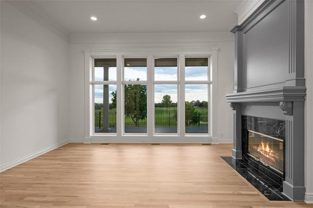 14005 Dearborn St, Overland Park, KS 66223 - unfurnished living room with a high end fireplace, light wood finished floors, crown molding, and recessed lighting