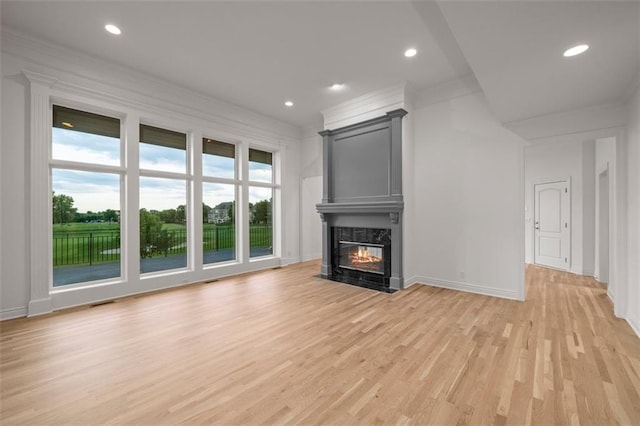 14005 Dearborn St, Overland Park, KS 66223 - unfurnished living room with light wood-style flooring, a high end fireplace, recessed lighting, and crown molding