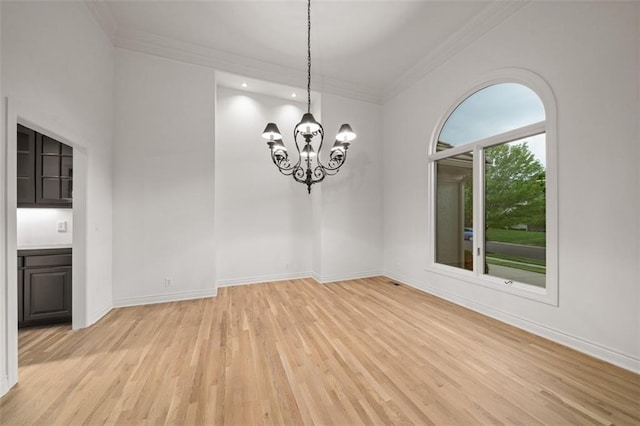 14005 Dearborn St, Overland Park, KS 66223 - unfurnished dining area with light wood-type flooring, ornamental molding, and a chandelier