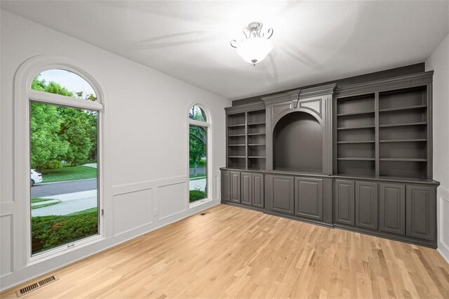 14005 Dearborn St, Overland Park, KS 66223 - unfurnished dining area featuring light wood finished floors and a decorative wall