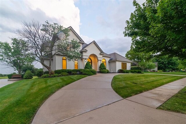 14005 Dearborn St, Overland Park, KS 66223 - view of front of house with stucco siding and a front yard