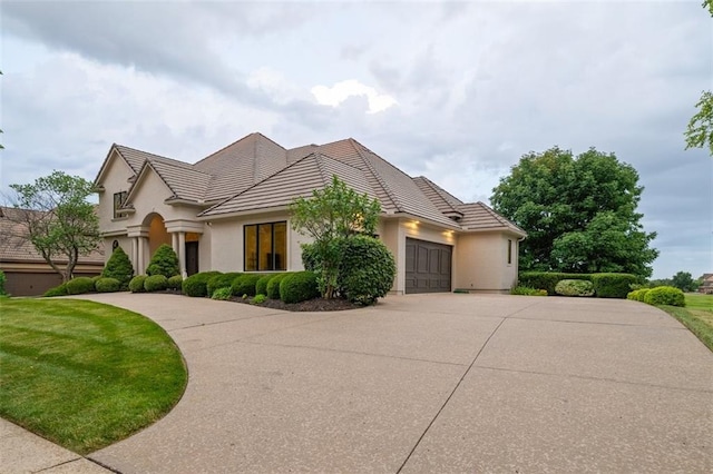 14005 Dearborn St, Overland Park, KS 66223 - view of front of home featuring driveway, an attached garage, stucco siding, and a tile roof