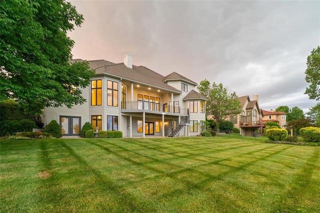 14005 Dearborn St, Overland Park, KS 66223 - back of house featuring a lawn, french doors, stucco siding, and a chimney