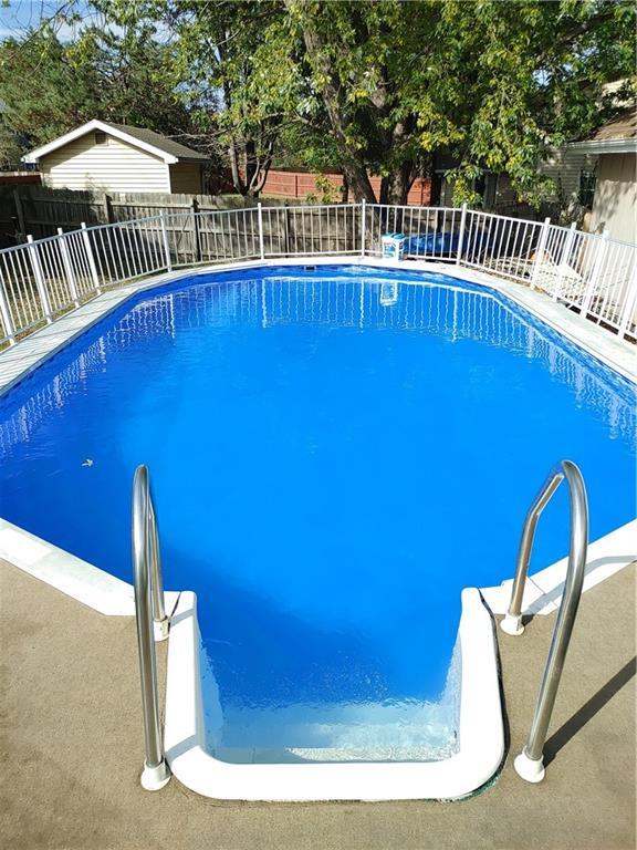 300 S Silver Top Ln, Raymore, MO 64083 - view of swimming pool featuring a fenced backyard
