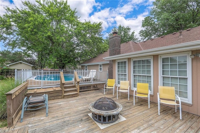300 S Silver Top Ln, Raymore, MO 64083 - deck with an outdoor fire pit