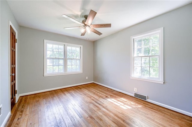 5301 Sycamore Dr, Roeland Park, KS 66205 - unfurnished room featuring healthy amount of natural light, hardwood / wood-style floors, and ceiling fan