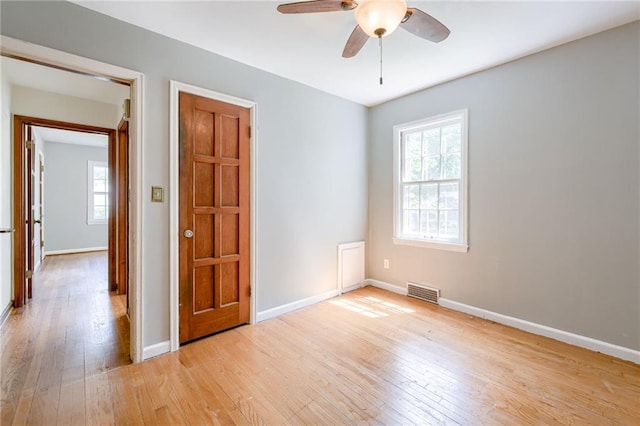 5301 Sycamore Dr, Roeland Park, KS 66205 - empty room featuring light wood-style flooring, plenty of natural light, and ceiling fan