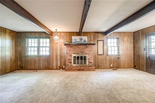 5301 Sycamore Dr, Roeland Park, KS 66205 - unfurnished living room featuring plenty of natural light, beamed ceiling, carpet flooring, wooden walls, and a fireplace