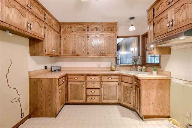 5301 Sycamore Dr, Roeland Park, KS 66205 - kitchen featuring light floors, brown cabinetry, and light countertops