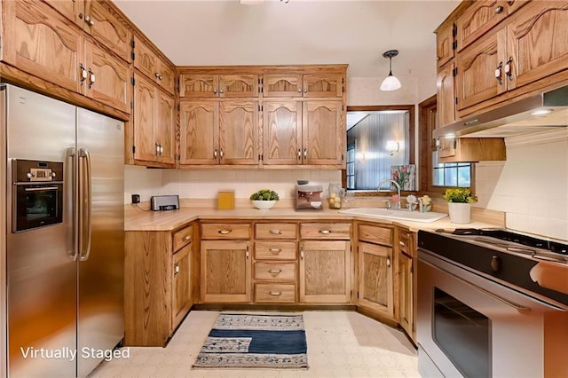 5301 Sycamore Dr, Roeland Park, KS 66205 - kitchen featuring stainless steel refrigerator with ice dispenser, gas range, light floors, and under cabinet range hood
