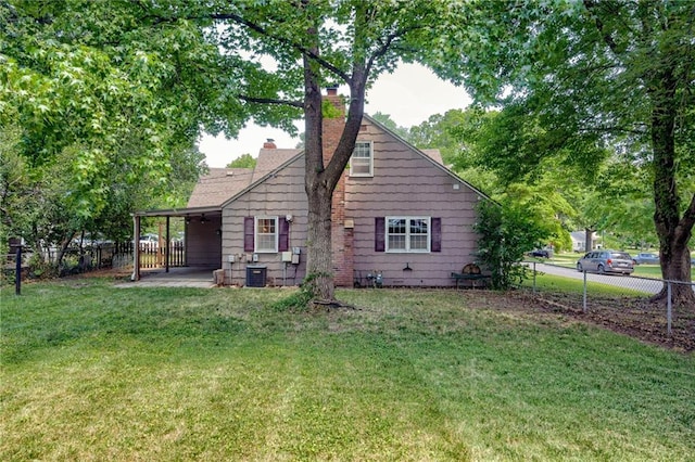 5301 Sycamore Dr, Roeland Park, KS 66205 - back of property with a chimney, a fenced backyard, and a patio area
