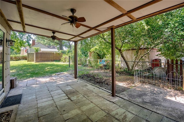 5301 Sycamore Dr, Roeland Park, KS 66205 - fenced backyard with ceiling fan and a patio