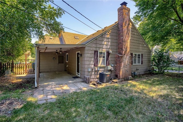 5301 Sycamore Dr, Roeland Park, KS 66205 - back of house featuring a chimney, a ceiling fan, and a shingled roof