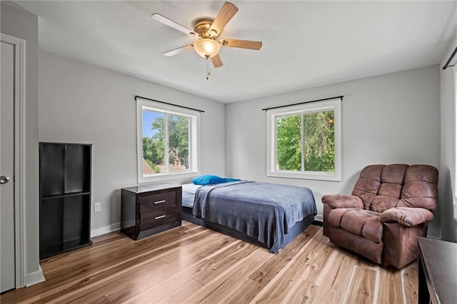 915 4th Ave, Leavenworth, KS 66048 - bedroom with multiple windows, light wood-type flooring, and a ceiling fan