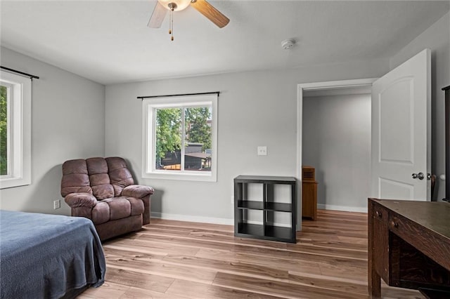 915 4th Ave, Leavenworth, KS 66048 - bedroom with multiple windows, light wood-style flooring, and a ceiling fan