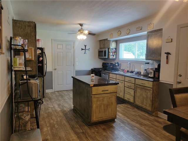 8218 W 87th St, Overland Park, KS 66212 - kitchen with appliances with stainless steel finishes, a sink, a ceiling fan, dark countertops, and dark wood-style flooring