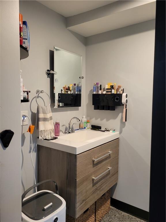 8218 W 87th St, Overland Park, KS 66212 - half bath featuring vanity, baseboards, and speckle patterned floor