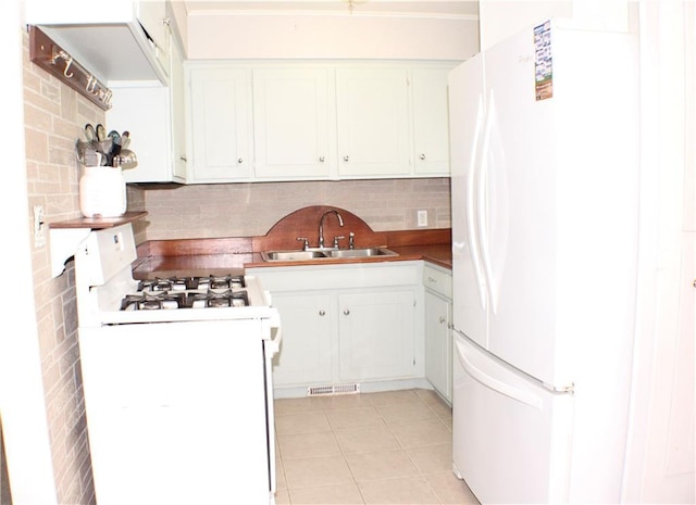 3801 N Osage St, Independence, MO 64050 - kitchen with white appliances, backsplash, light tile patterned floors, white cabinetry, and ornamental molding