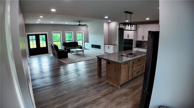 25908 E 317th Ter, Harrisonville, MO 64701 - kitchen with open floor plan, recessed lighting, dark wood-style floors, white cabinetry, and black appliances
