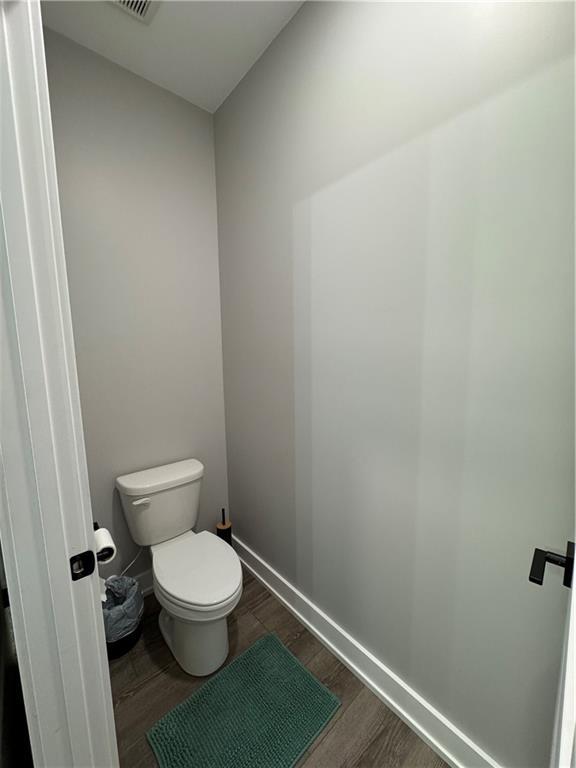 25908 E 317th Ter, Harrisonville, MO 64701 - bathroom featuring wood finished floors and toilet