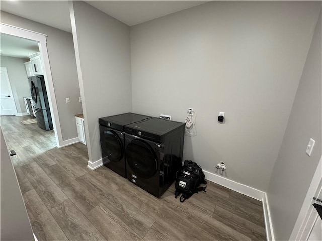 25908 E 317th Ter, Harrisonville, MO 64701 - washroom with wood finished floors, baseboards, and washer and dryer
