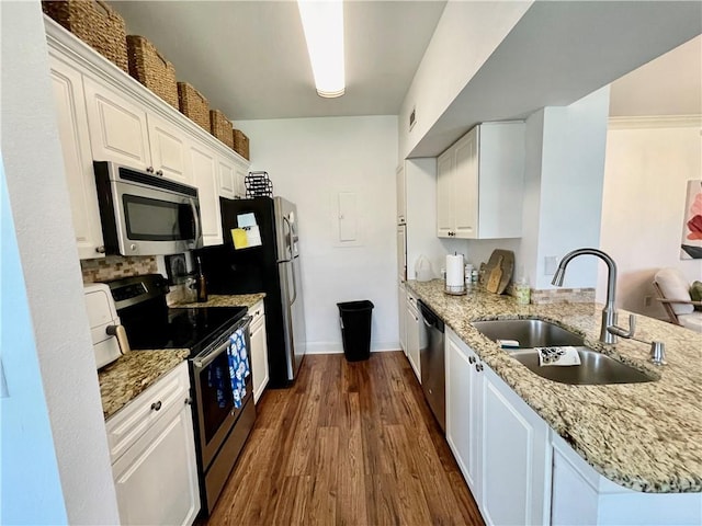 11619 Tomahawk Creek Pkwy Unit B, Leawood, KS 66211 - kitchen with stainless steel appliances, a sink, white cabinetry, dark wood-style floors, and light stone counters