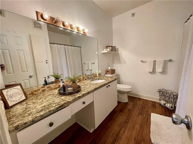 11619 Tomahawk Creek Pkwy Unit B, Leawood, KS 66211 - full bathroom featuring wood finished floors, toilet, vanity, baseboards, and a shower with curtain
