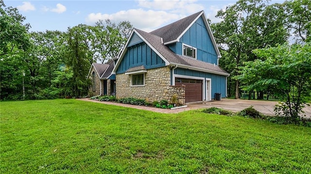 26725 S Bennett Rd, Freeman, MO 64746 - view of home's exterior with board and batten siding, concrete driveway, stone siding, and a lawn