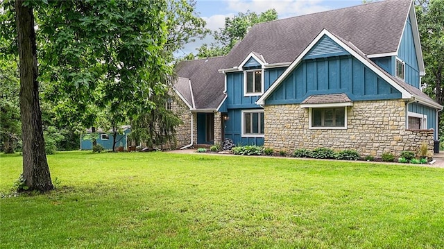 26725 S Bennett Rd, Freeman, MO 64746 - craftsman inspired home featuring board and batten siding, stone siding, a front lawn, and roof with shingles