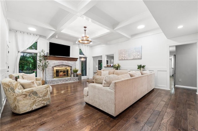 26725 S Bennett Rd, Freeman, MO 64746 - living area with dark wood-style flooring, beamed ceiling, a brick fireplace, coffered ceiling, and a chandelier