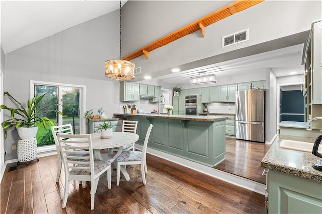 26725 S Bennett Rd, Freeman, MO 64746 - dining space featuring a chandelier, high vaulted ceiling, and dark wood finished floors