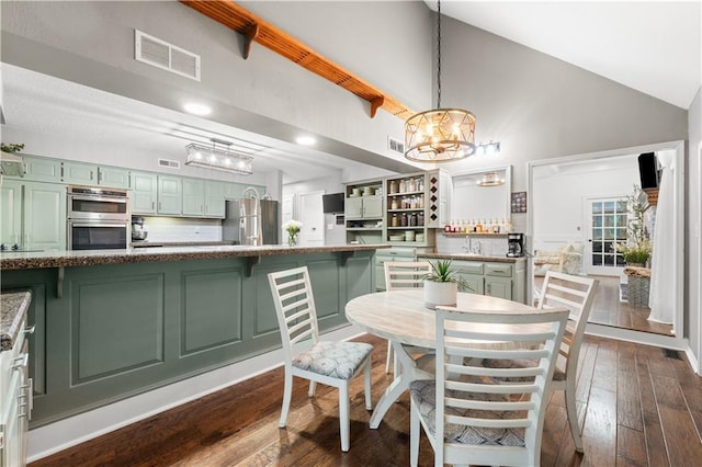 26725 S Bennett Rd, Freeman, MO 64746 - dining space featuring a chandelier, dark wood-style floors, and high vaulted ceiling