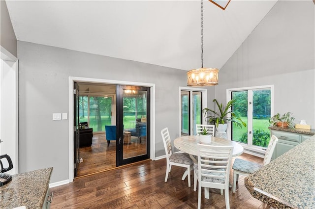 26725 S Bennett Rd, Freeman, MO 64746 - dining room featuring a chandelier, dark wood-type flooring, baseboards, and high vaulted ceiling