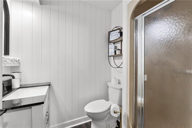 26725 S Bennett Rd, Freeman, MO 64746 - bathroom with toilet, a stall shower, wood finished floors, and vanity