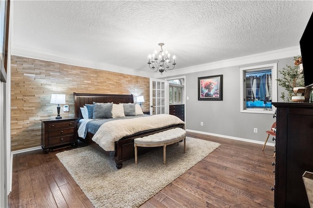 26725 S Bennett Rd, Freeman, MO 64746 - bedroom with a textured ceiling, baseboards, a chandelier, dark wood-style floors, and ornamental molding