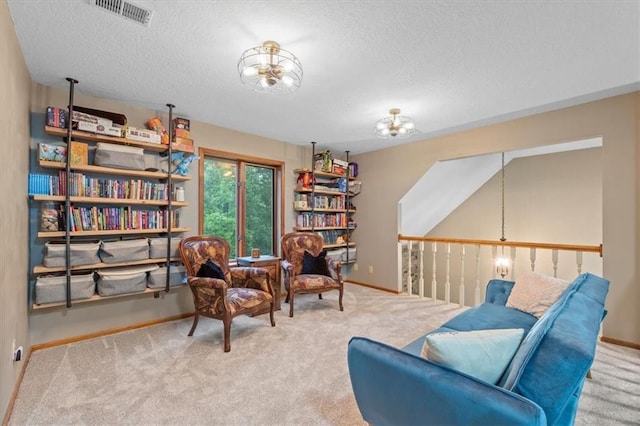 26725 S Bennett Rd, Freeman, MO 64746 - living area featuring carpet flooring, baseboards, a textured ceiling, and a chandelier