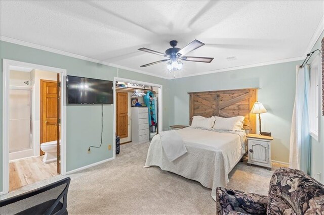 26725 S Bennett Rd, Freeman, MO 64746 - bedroom featuring a spacious closet, crown molding, a textured ceiling, a closet, and a ceiling fan
