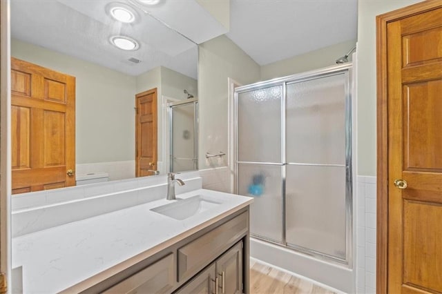 26725 S Bennett Rd, Freeman, MO 64746 - bathroom with vanity, a stall shower, and wood finished floors