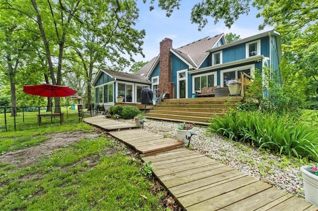 26725 S Bennett Rd, Freeman, MO 64746 - rear view of property featuring a sunroom, a deck, and a chimney