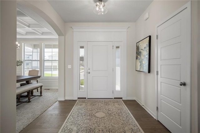 11487 S Cornice St, Olathe, KS 66061 - foyer featuring dark wood-style flooring, arched walkways, baseboards, beamed ceiling, and coffered ceiling