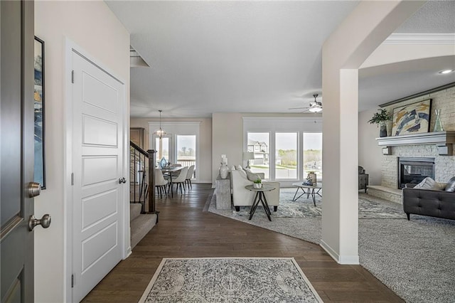 11487 S Cornice St, Olathe, KS 66061 - entrance foyer with a large fireplace, a ceiling fan, wood finished floors, stairway, and baseboards