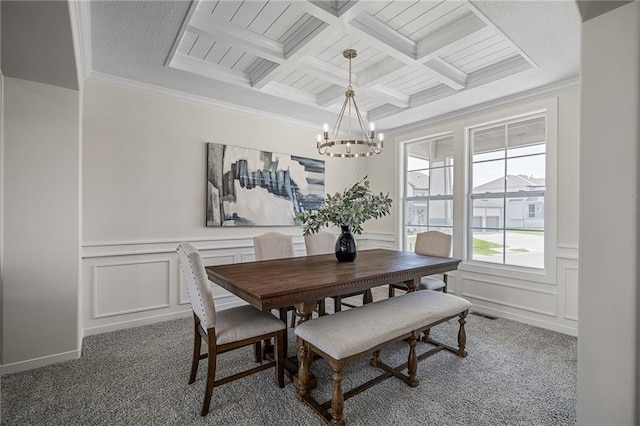 11487 S Cornice St, Olathe, KS 66061 - carpeted dining area featuring a chandelier, beam ceiling, a decorative wall, coffered ceiling, and ornamental molding