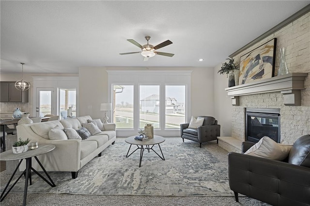 11487 S Cornice St, Olathe, KS 66061 - living room with ceiling fan, healthy amount of natural light, carpet floors, and a large fireplace