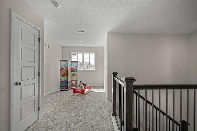 11487 S Cornice St, Olathe, KS 66061 - hallway featuring an upstairs landing, carpet flooring, a textured ceiling, and baseboards