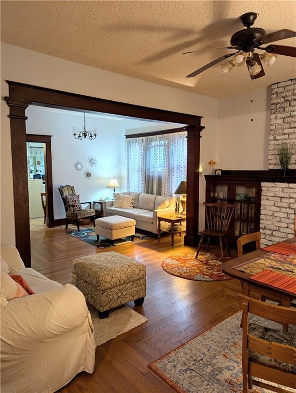 429 N 12th St, Fredonia, KS 66736 - living room featuring a ceiling fan and a textured ceiling